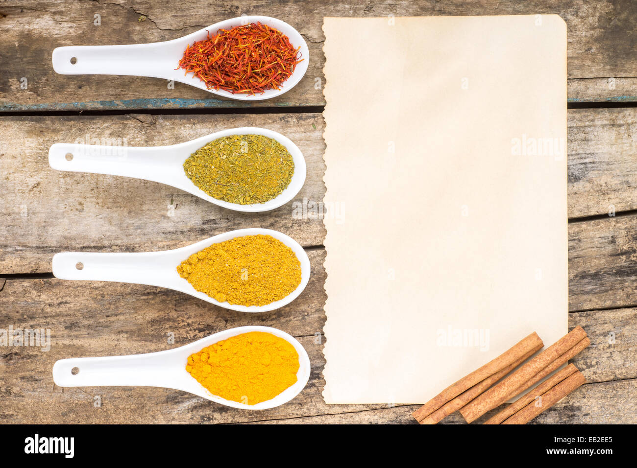 Spices recipe background. Diversity of spicy powder with paper sheet. Top View Stock Photo