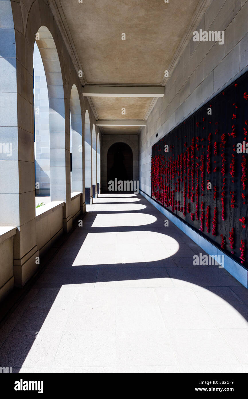Cloisters containing the Roll of Honour and the names of fallen soldiers remembered with bright red poppies. Stock Photo