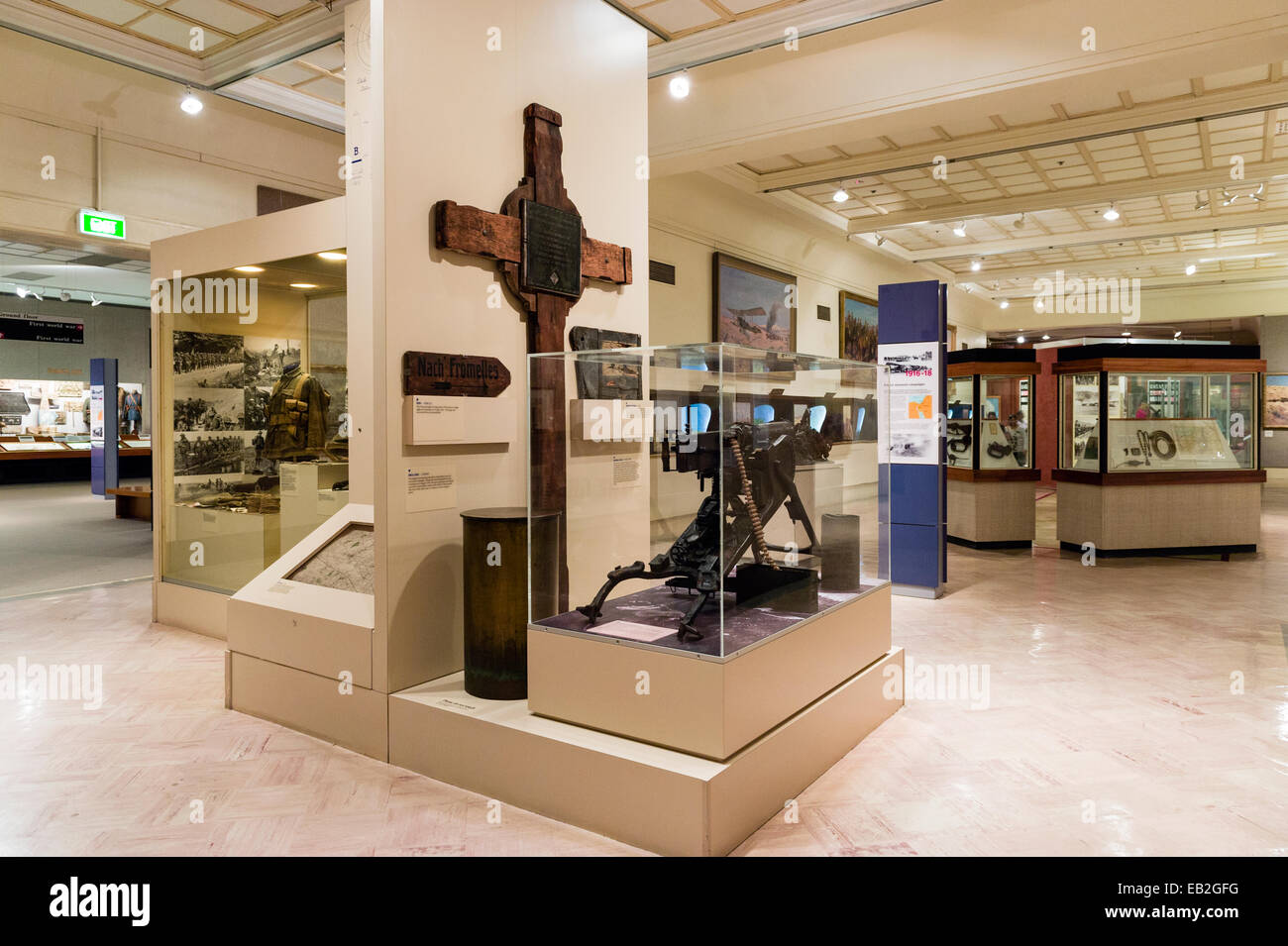 A museum gallery displaying a German machine gun and memorial cross from the First World War. Stock Photo