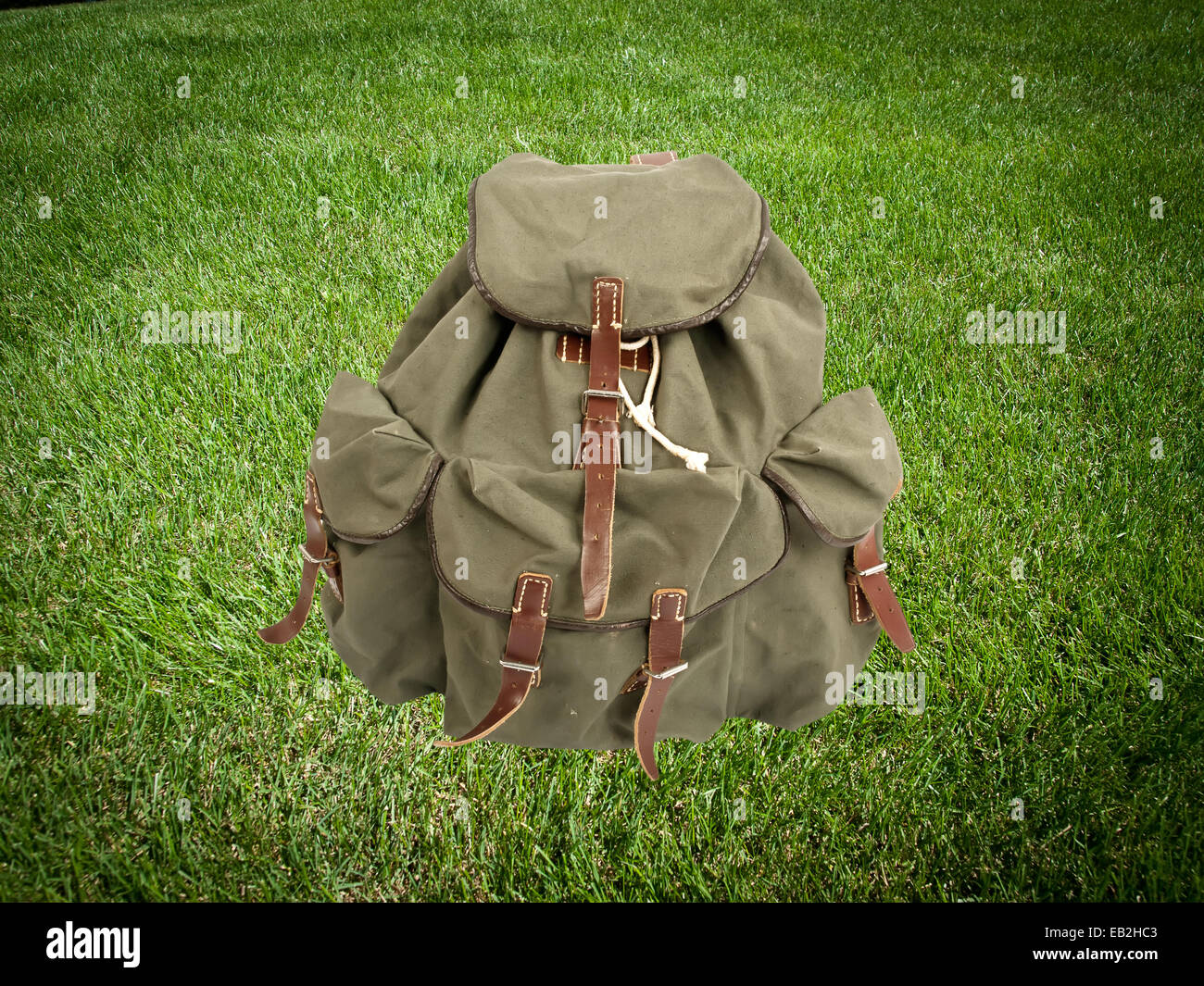 adventure backpack on green grass Stock Photo