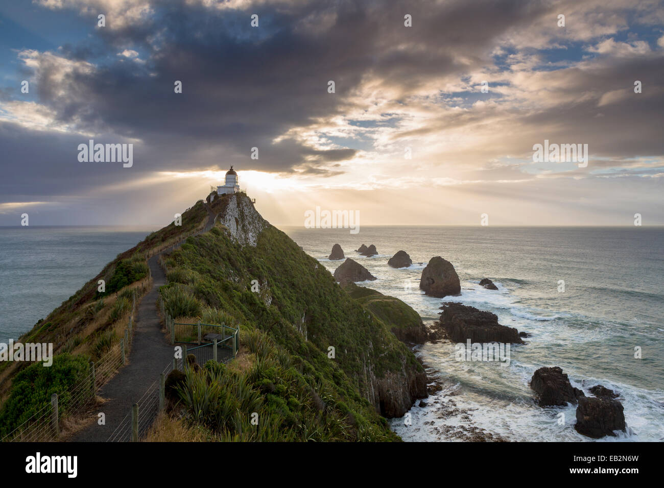 The Lighthouse at Nugget Point at sunrise, Nugget Point, Ahuriri Flat, Otago Region, New Zealand Stock Photo