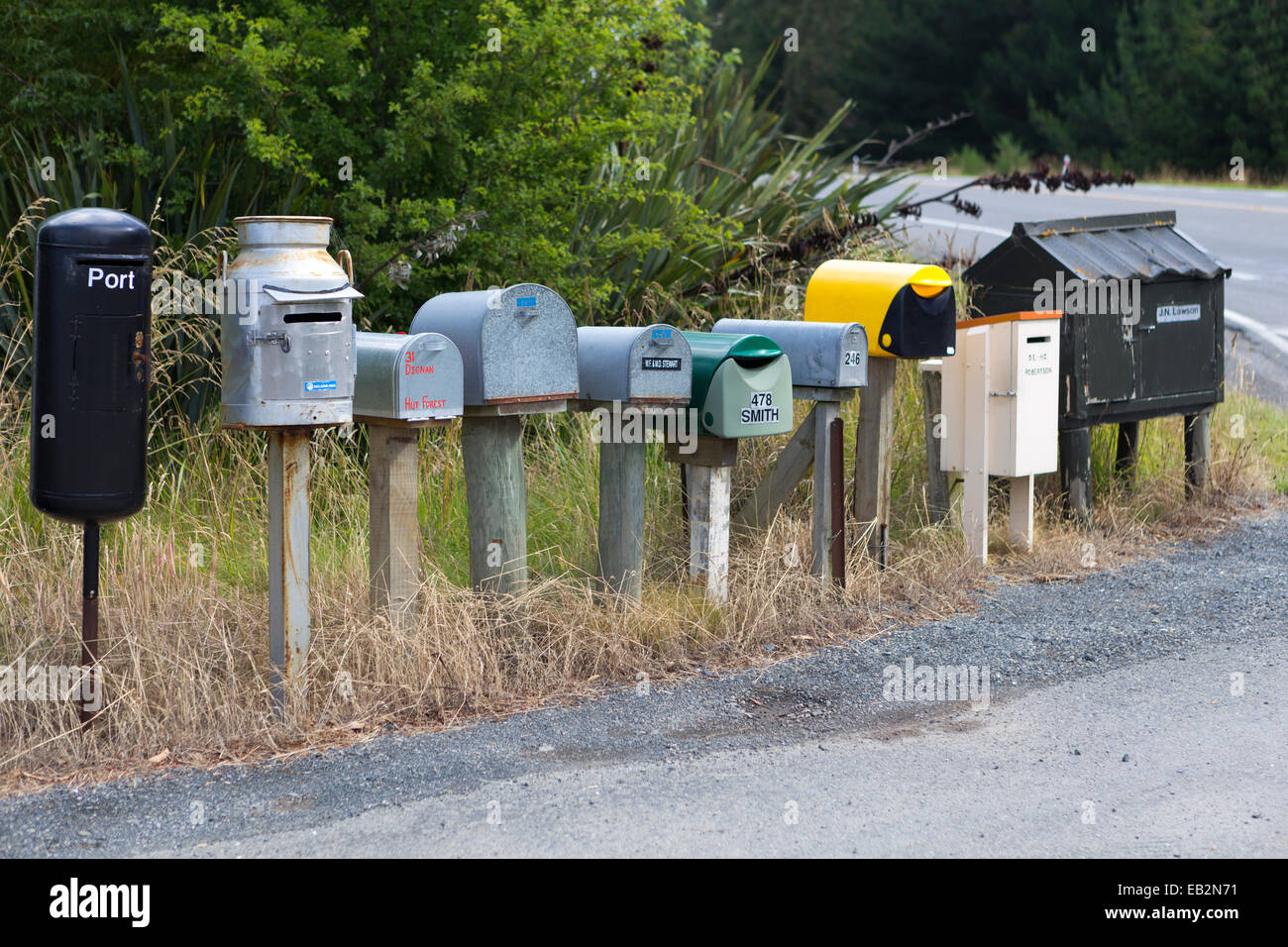 Row of different mailboxes on the roadside, Seacliff, Otago Region, New Zealand Stock Photo