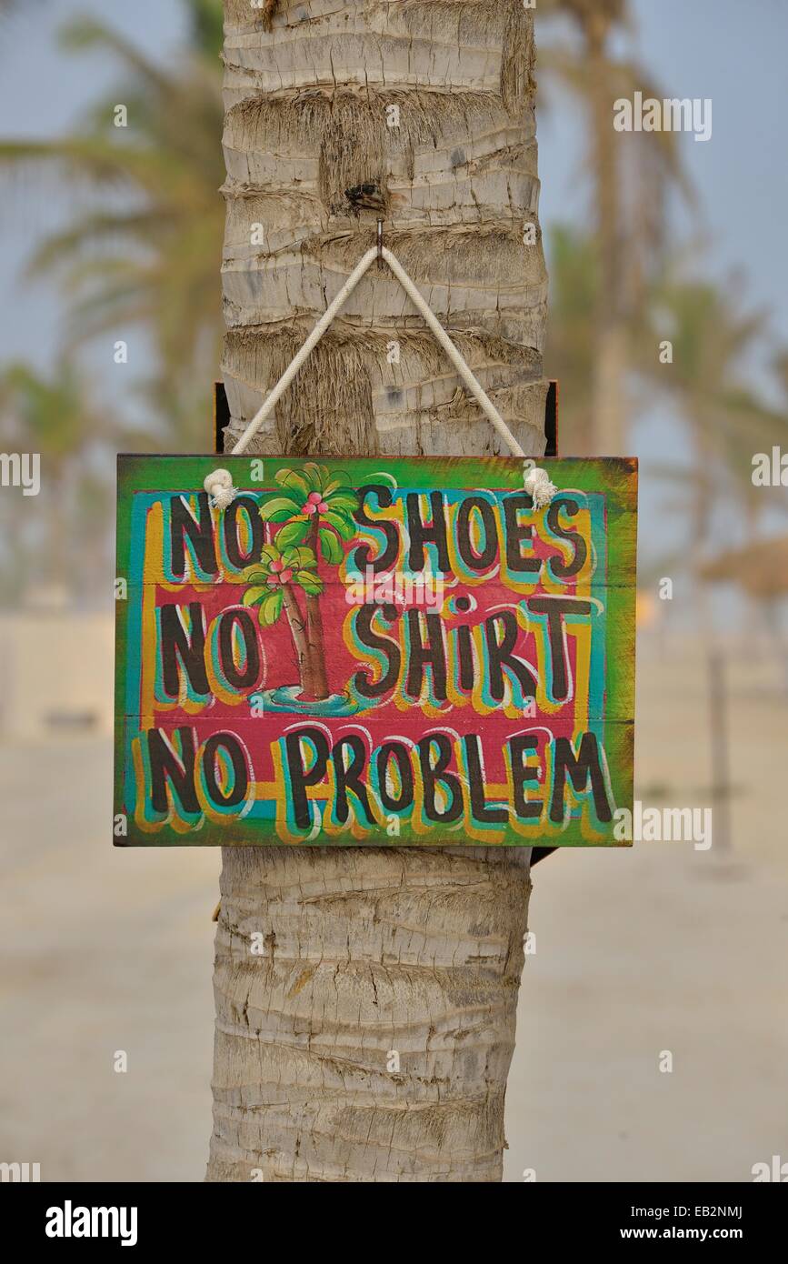 Sign 'No shoes, no shirt, no problem' on the beach of Salalah Rotana Resort, Salalah, Dhofar Region, Oman Stock Photo