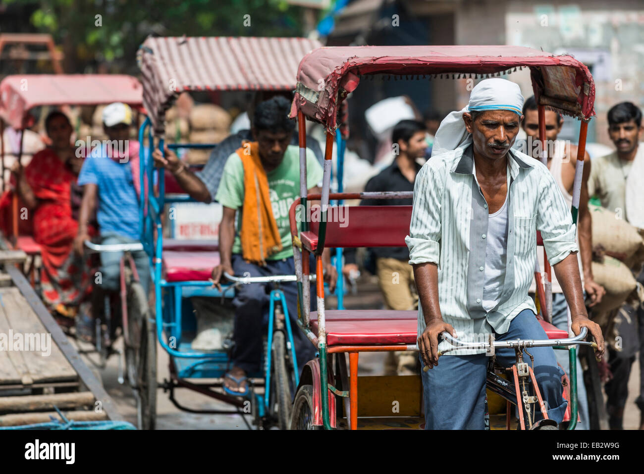 Cycle rickshaws queuing up on crowded Khari Baoli Road, Old Delhi, New Delhi, Delhi, India Stock Photo