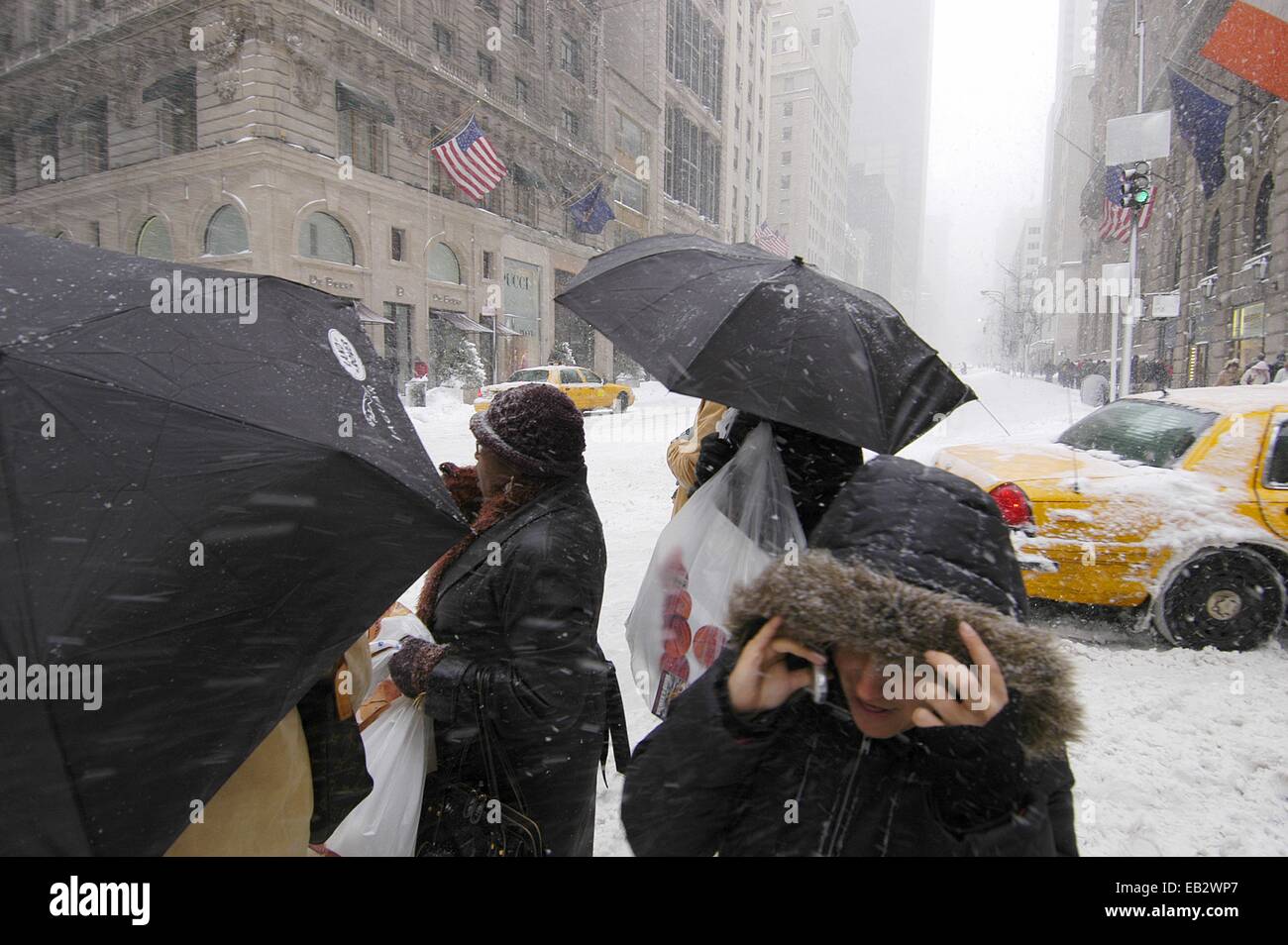 People walking in a street in New York City during a blizzard. Stock Photo
