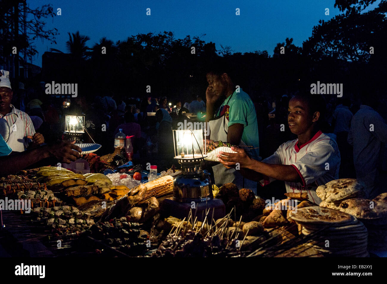 Food stall vendors prepare fresh food for shoppers at a night market by the Indian Ocean. Stock Photo