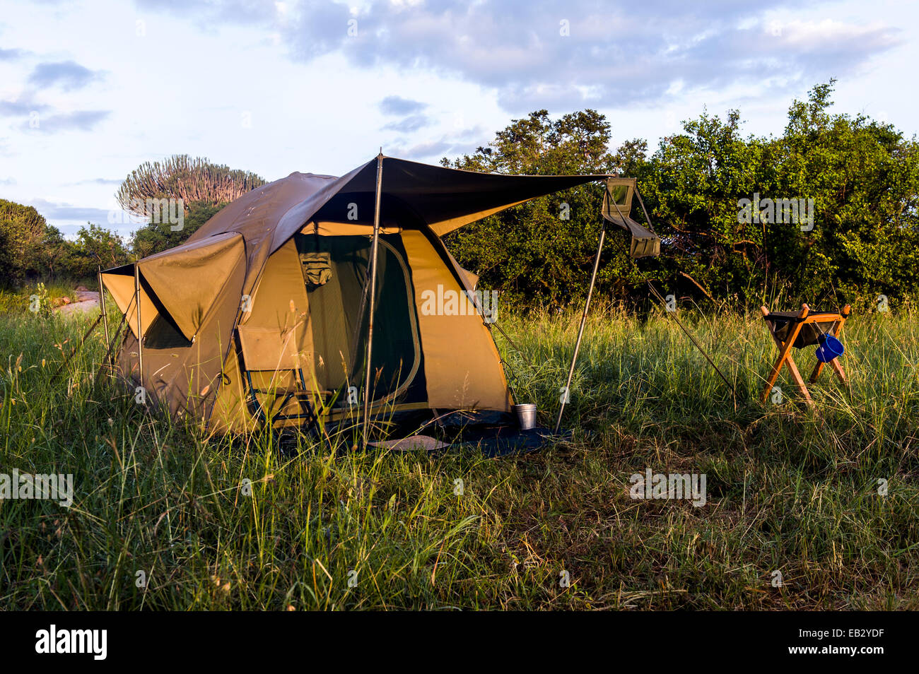 A safari tent with a verandah in a remote grassland campsite on the savannah. Stock Photo