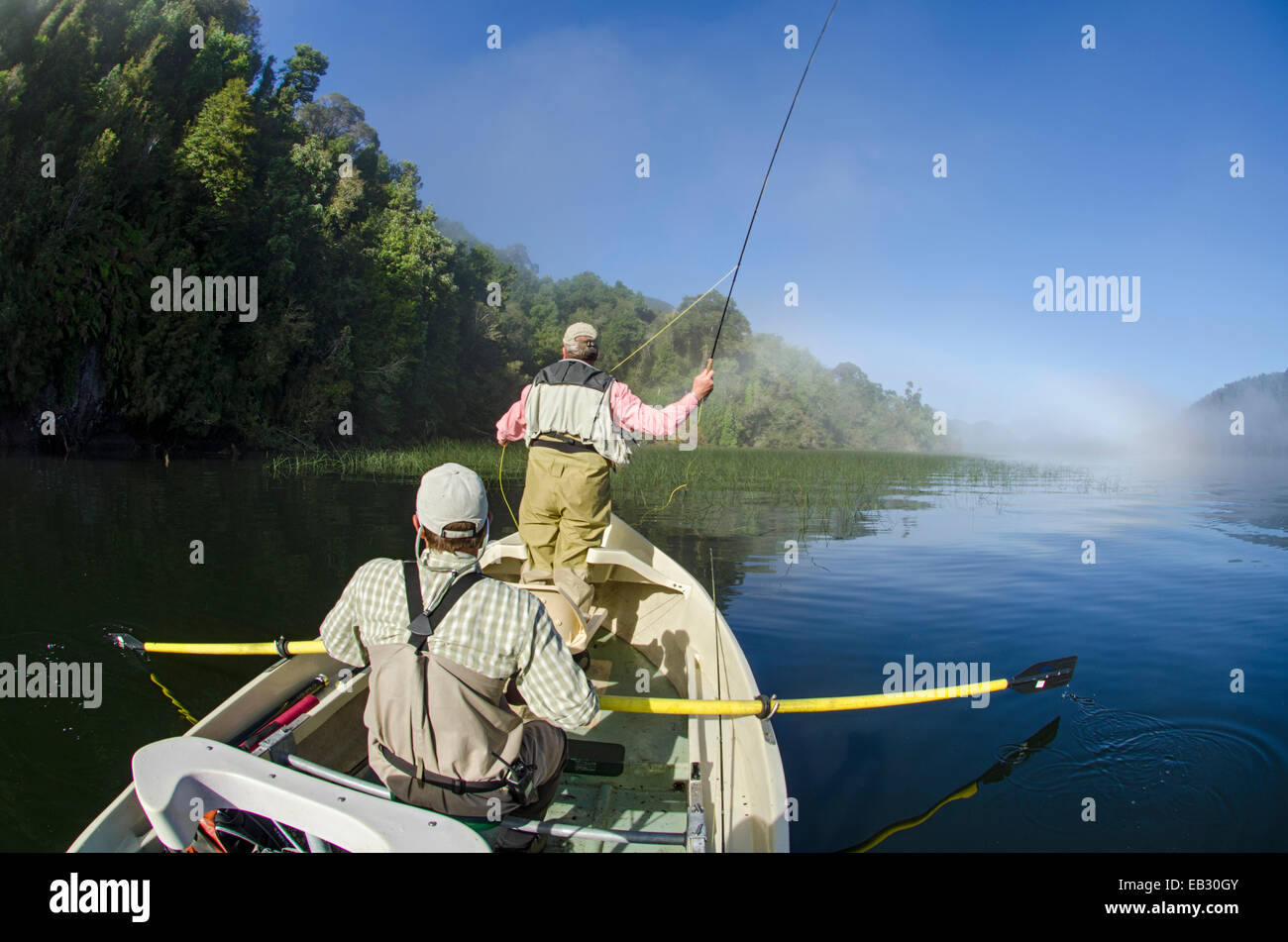 Flyfishing under an early morning fogbow on Ceasar Lake in Corcovado National Park. Stock Photo
