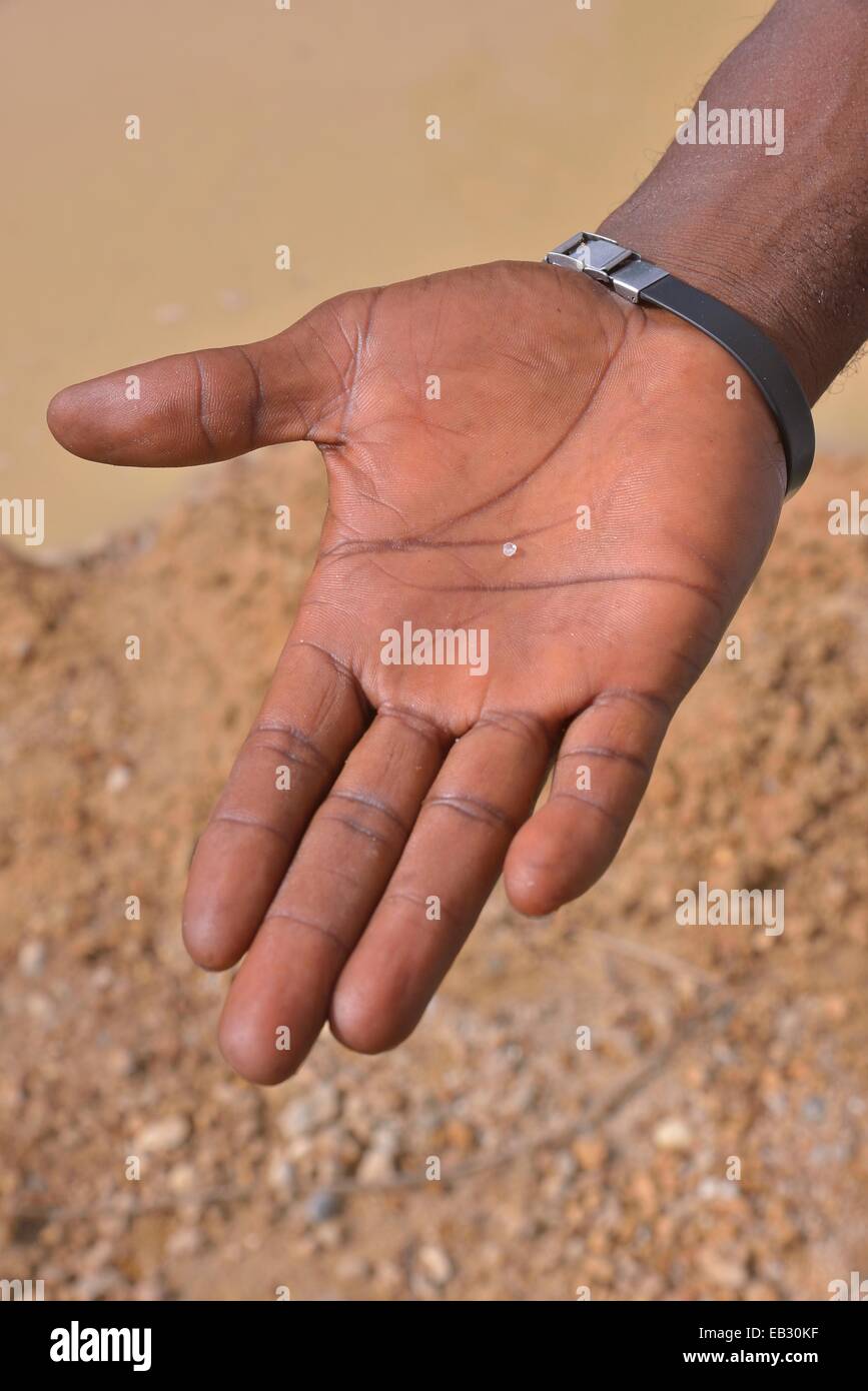 Hand of a diamond hunter displaying a diamond, near Koidu, Koidu-Sefadu, Kono District, Eastern Province, Sierra Leone Stock Photo