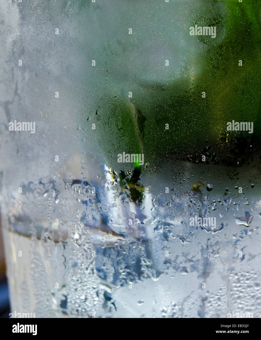 Condensation on outside of chilled glass containing ice and drinking fluid Stock Photo