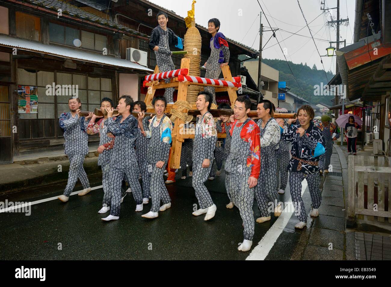 Shinto festival, Matsuri, in which self-made fireworks wrapped with straw ropes are carried by the approaching darkness on a Stock Photo