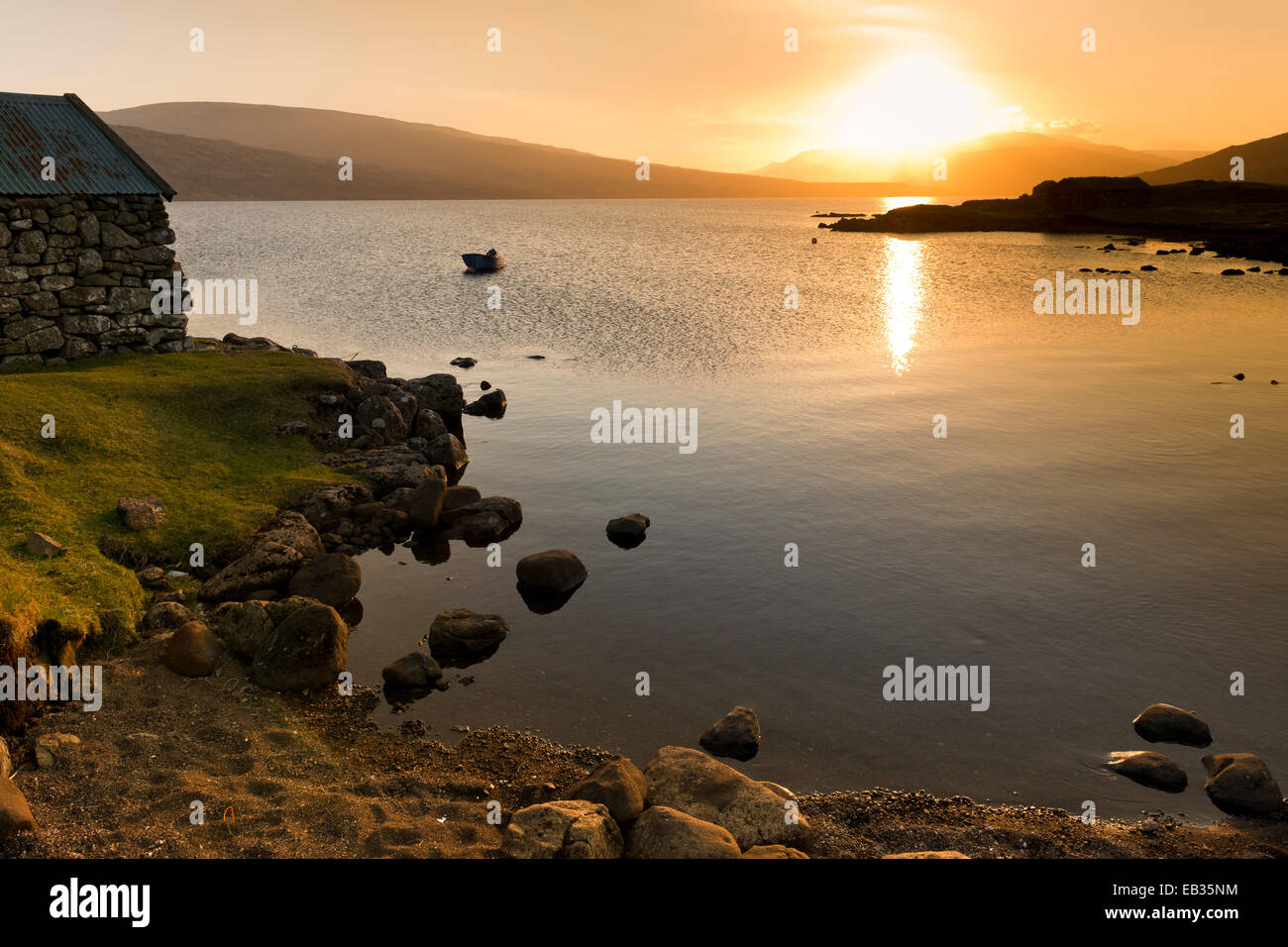 Lake Sørvágsvatn or Leitisvatn, boat house, cove, sunset, Vágar, Faroe Islands, Denmark Stock Photo