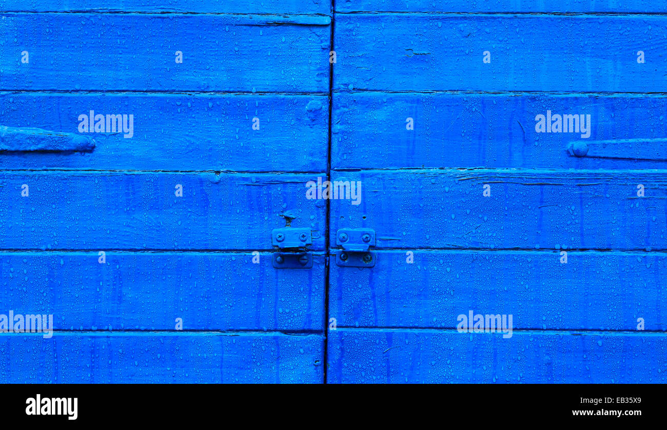 Wooden shutter painted blue. Stock Photo