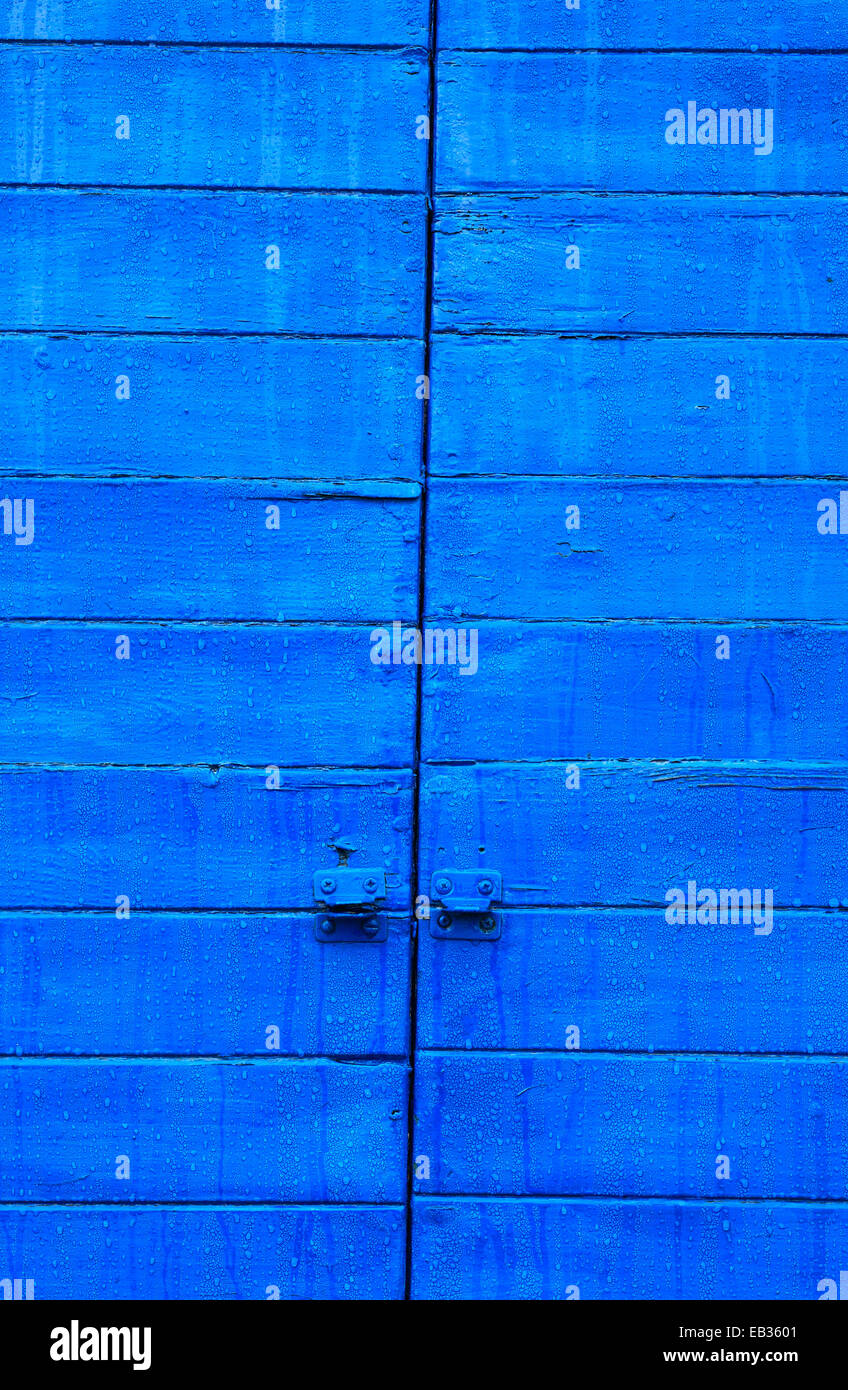 Wooden shutter painted blue. Stock Photo