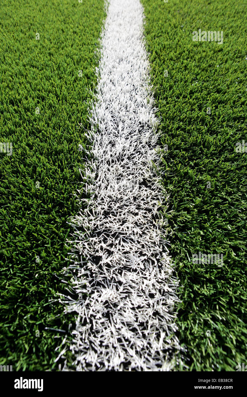 Close up of artificial grass on a rugby training field with a white line. Stock Photo