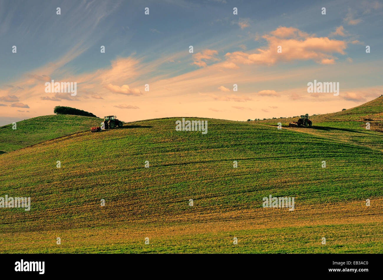 Two tractors ploughing a field, Alentejo,  Portugal Stock Photo