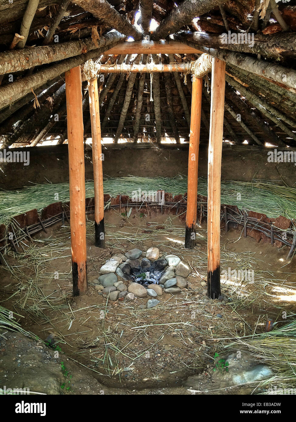 Rock fire pit in native wooden building - Smartphone Captured Stock Image