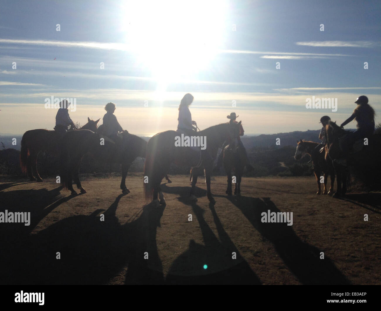 Silhouette of people riding horses in remote landscape - Smartphone Captured Stock Image