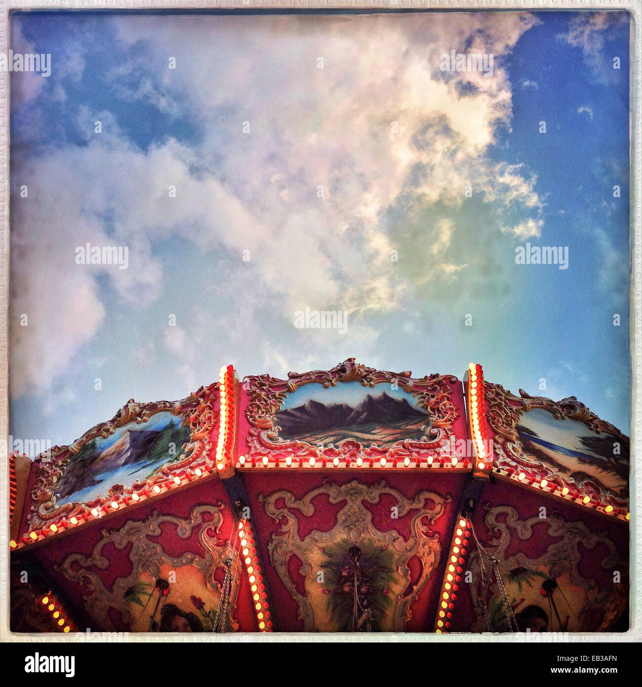 Low angle view of carousel under blue sky - Smartphone Captured Stock Image
