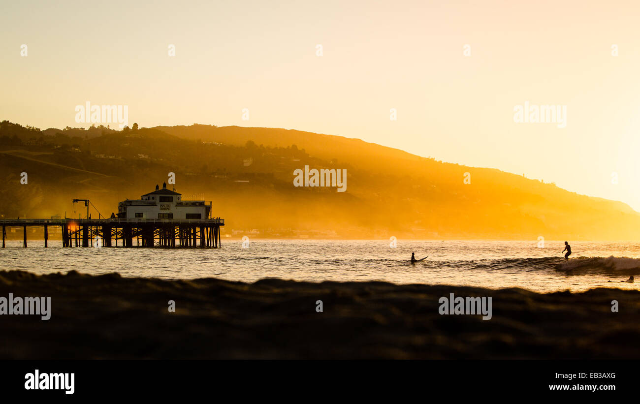 Silhouette of surfers and Pier at sunrise, Malibu, California, USA Stock Photo