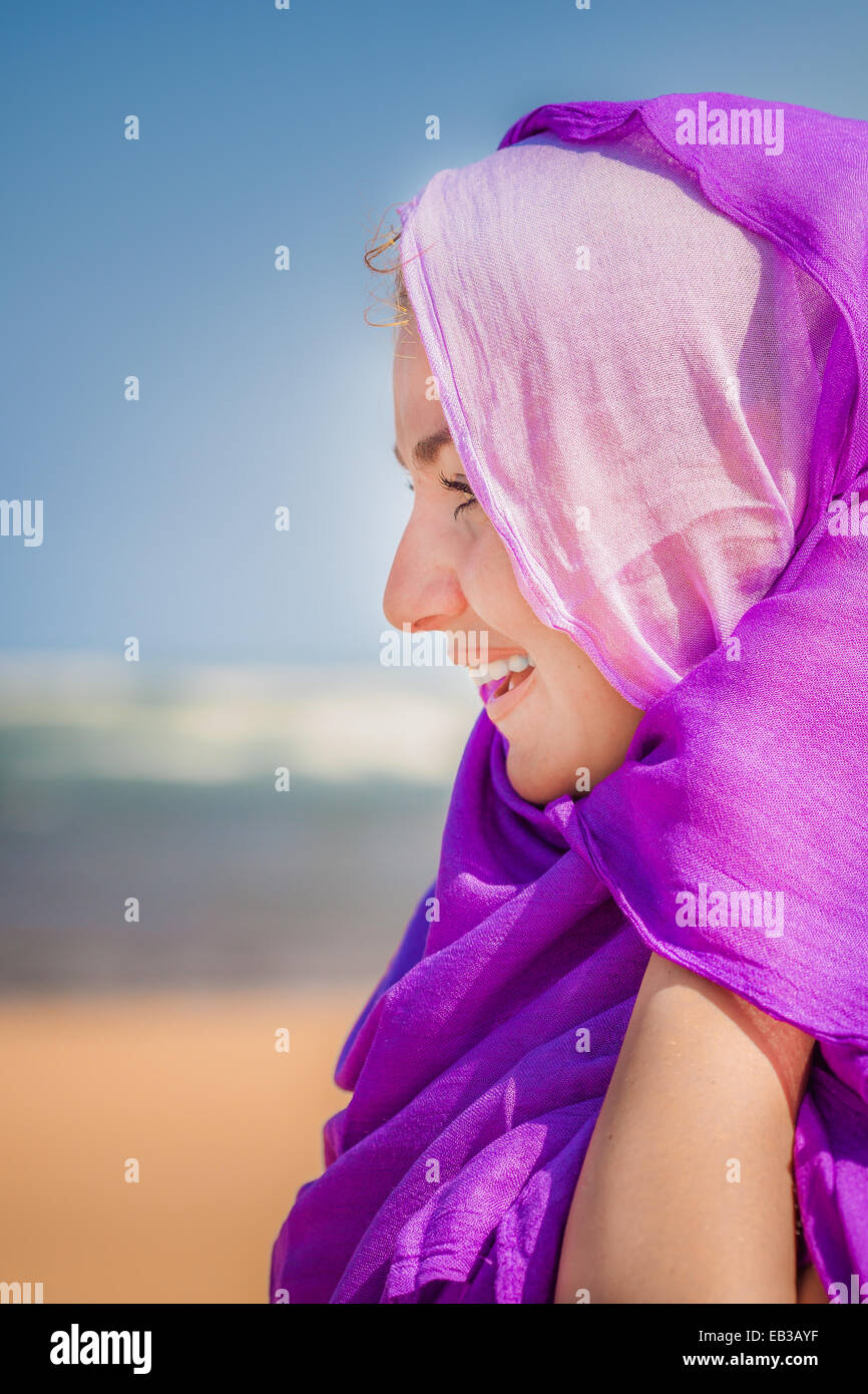 Woman with pink and purple scarves on head Stock Photo