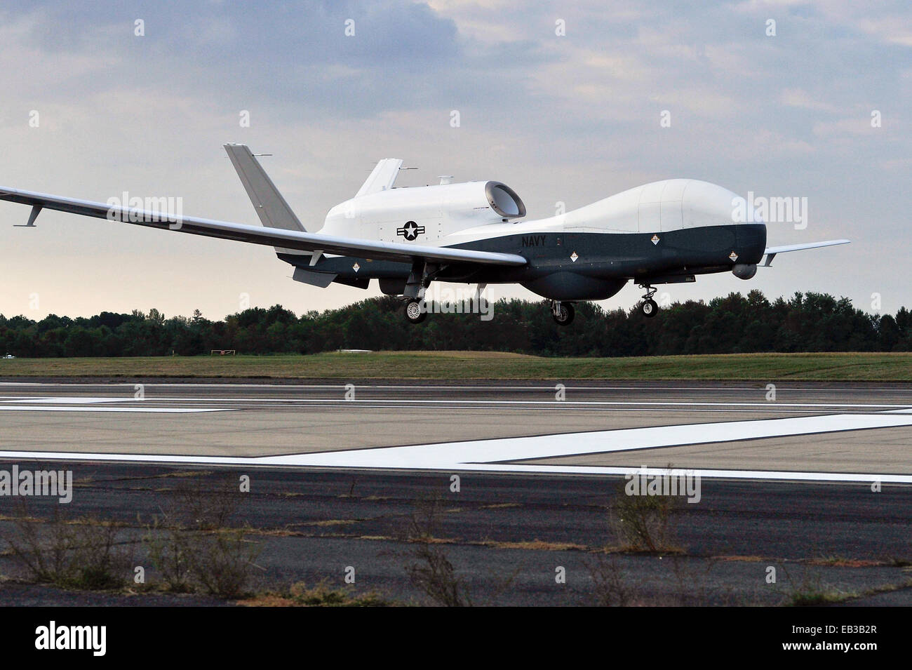 A US Navy MQ-4C Triton Unmanned Aircraft System lands at Naval Air Station Patuxent River following the first cross country flight September 18, 2014 in Patuxent River, Maryland. Stock Photo