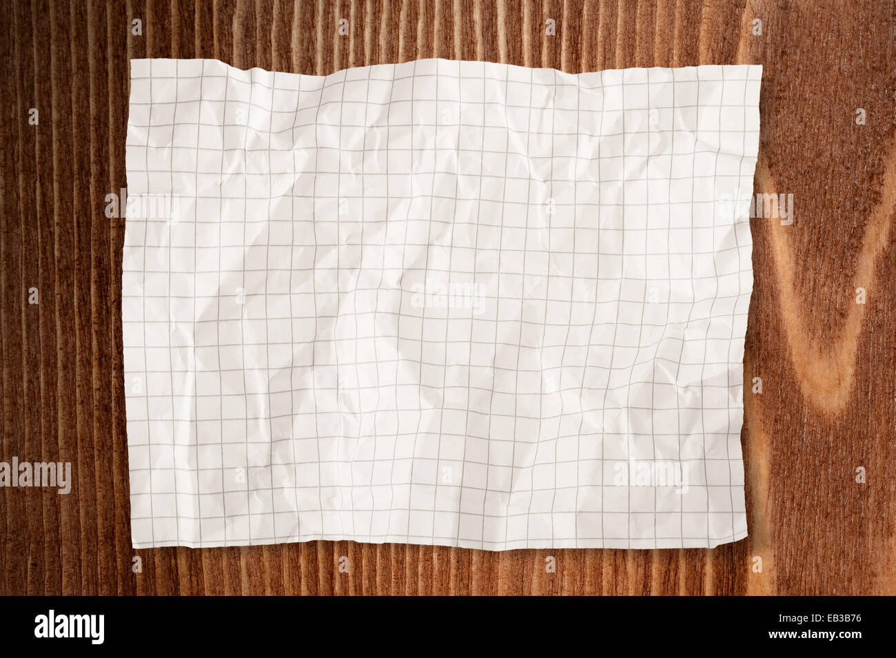 Paper Crumpled on wood background Stock Photo