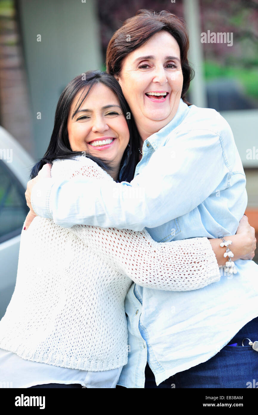 Hispanic women hugging Stock Photo