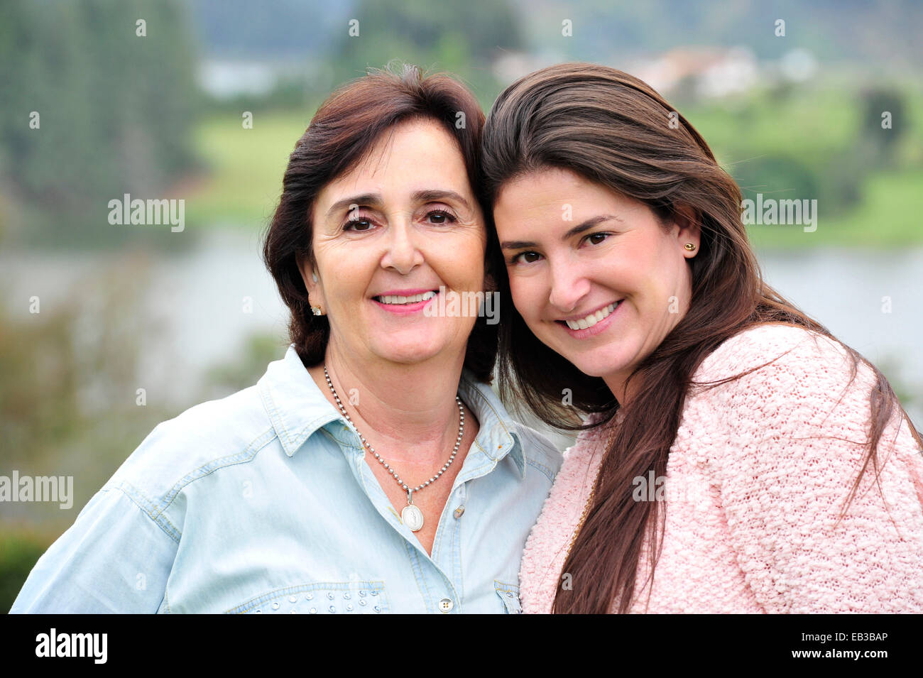 Hispanic mother and daughter smiling together Stock Photo