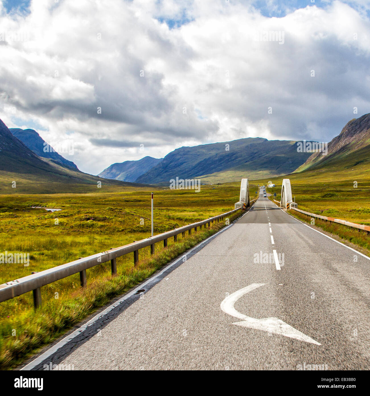 UK, Scotland, Road among plain leading towards mountains Stock Photo