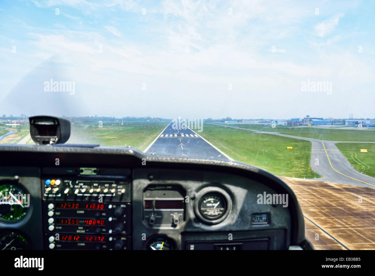 View of an airport runway from the cockpit of an aircraft Stock Photo