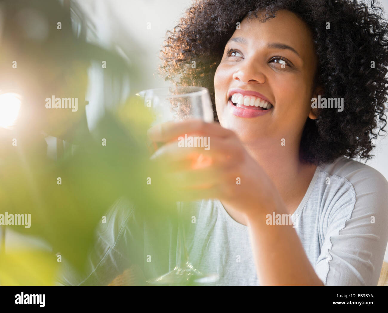 Smiling woman drinking glass of wine Stock Photo