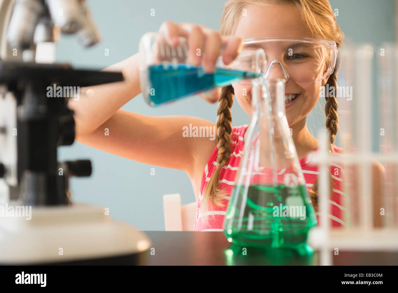 Caucasian girl doing science experiment in lab Stock Photo