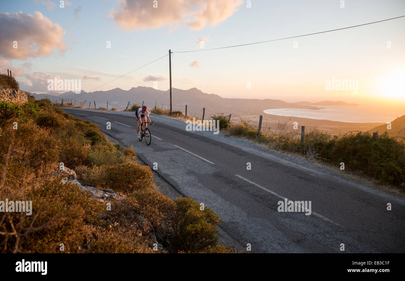 France, Corsica, Road cycling above sea at sunset Stock Photo