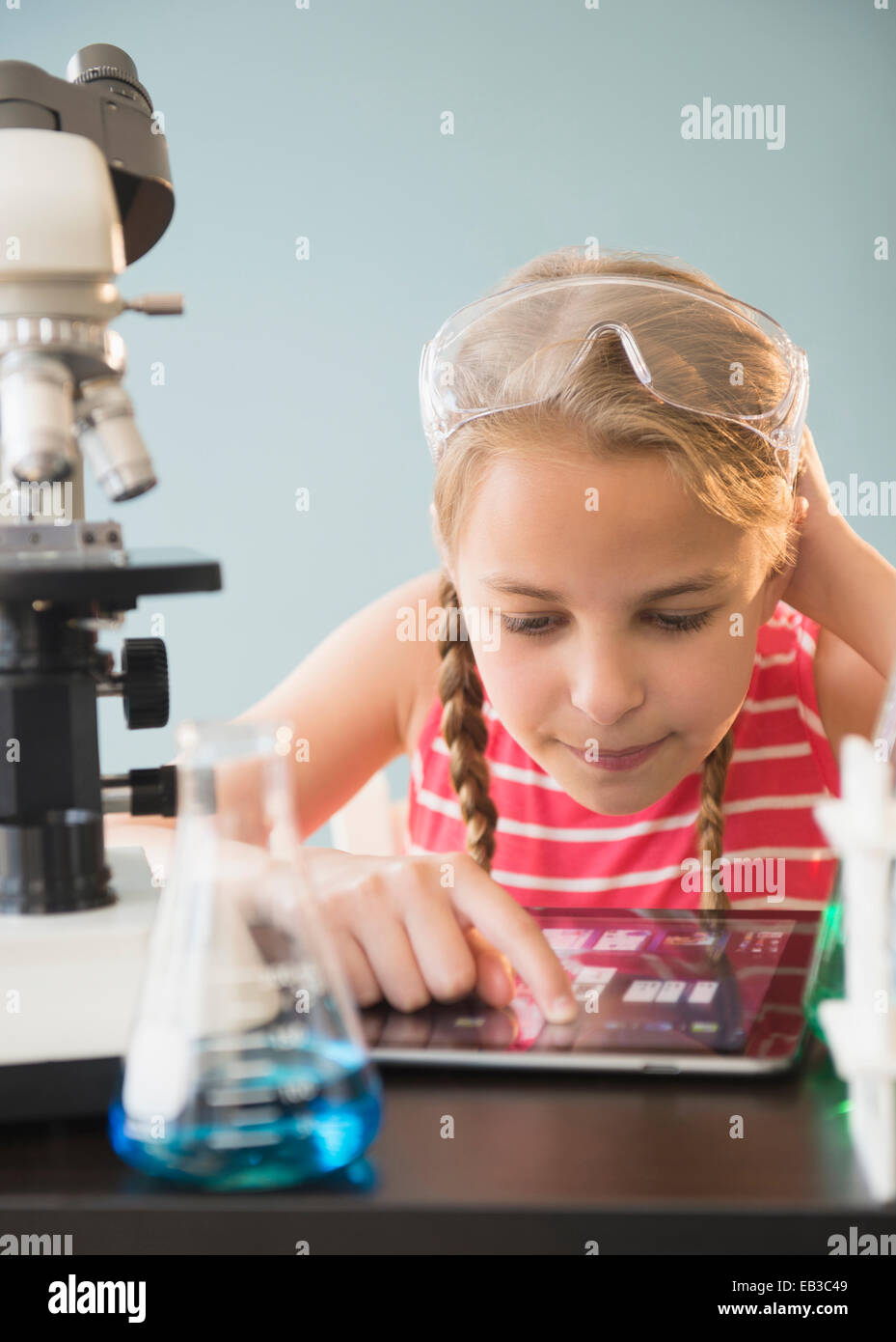 Caucasian girl using digital tablet in science lab Stock Photo