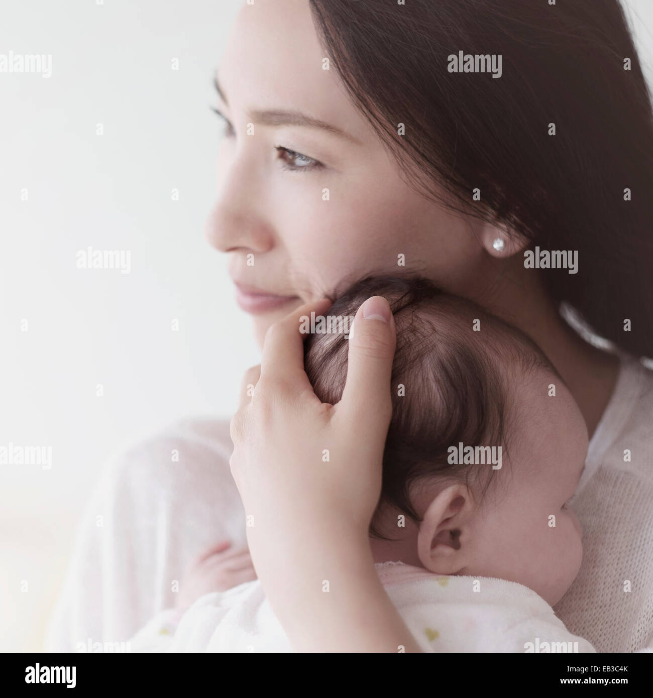 Asian mother holding baby Stock Photo