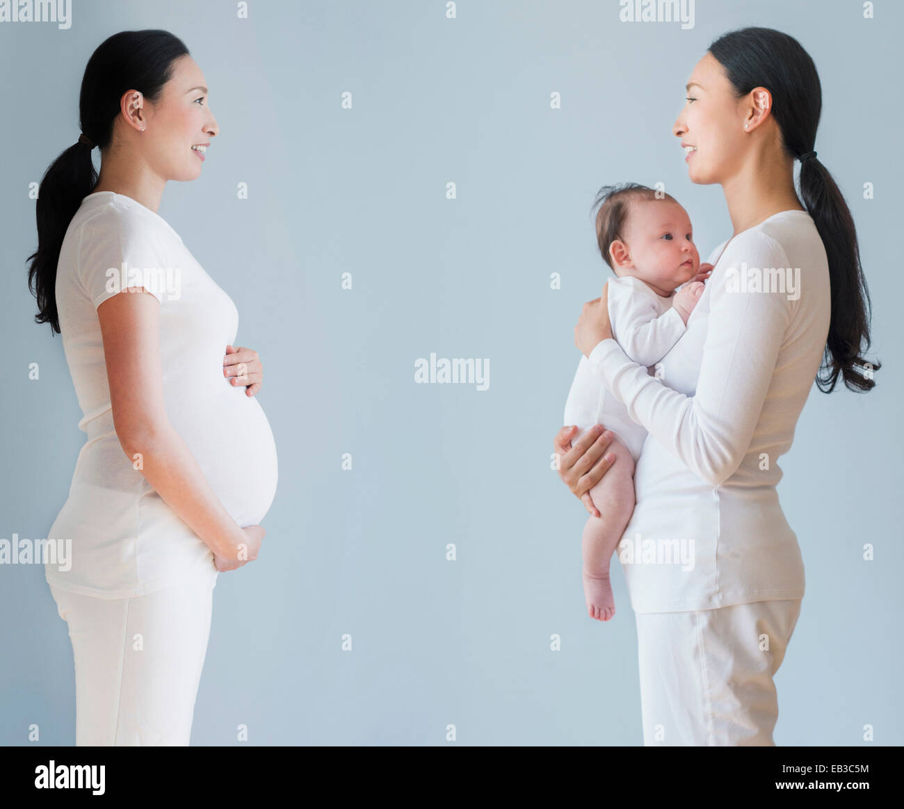 Double exposure of pregnant Asian mother before and after birth of baby Stock Photo