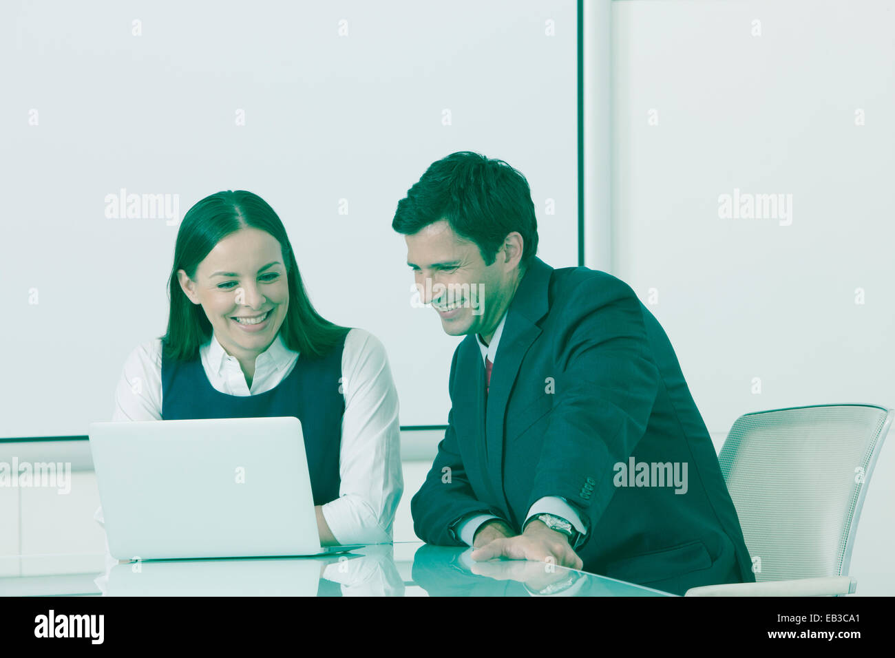 Businessman and businesswoman having meeting in conference room Stock ...