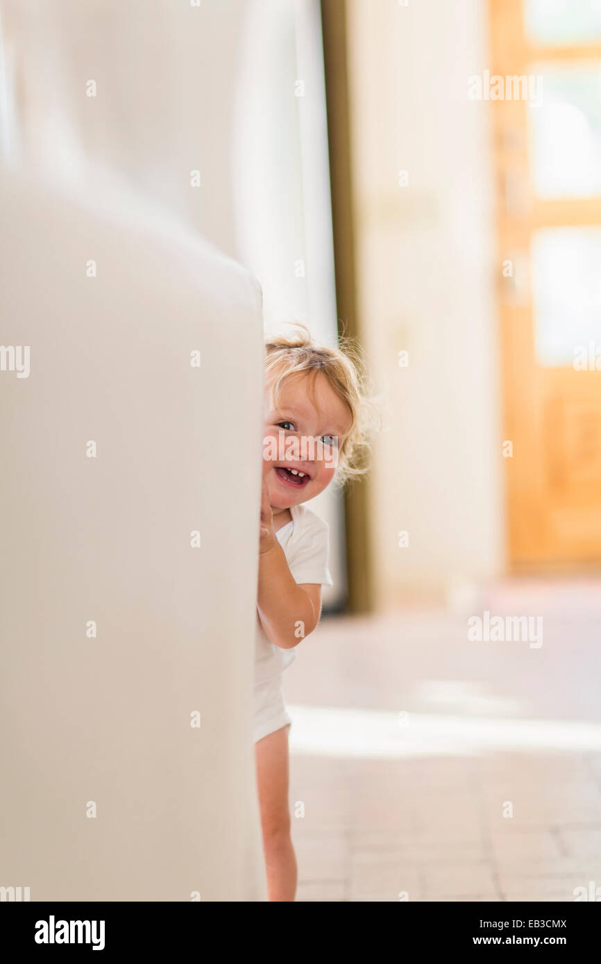 Caucasian baby boy playing hide and seek Stock Photo