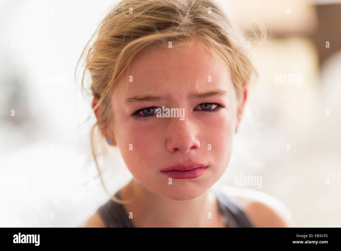 Close up of red face of crying Caucasian girl Stock Photo