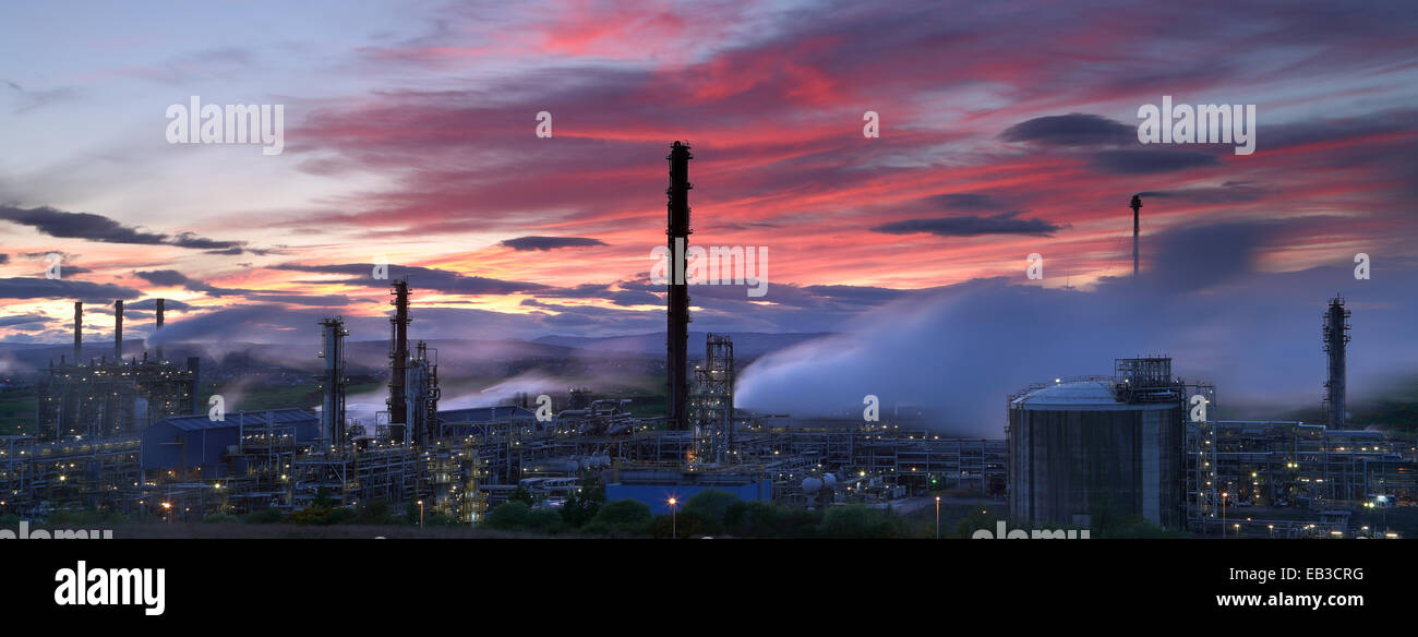 Illuminated natural gas processing plant at dusk Stock Photo