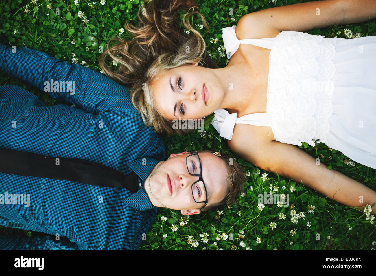 Overhead view of a couple lying on grass Stock Photo