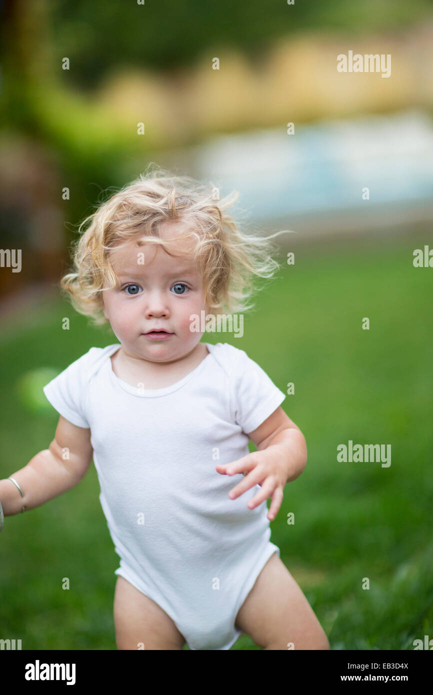 Caucasian baby boy walking in grass Stock Photo Alamy