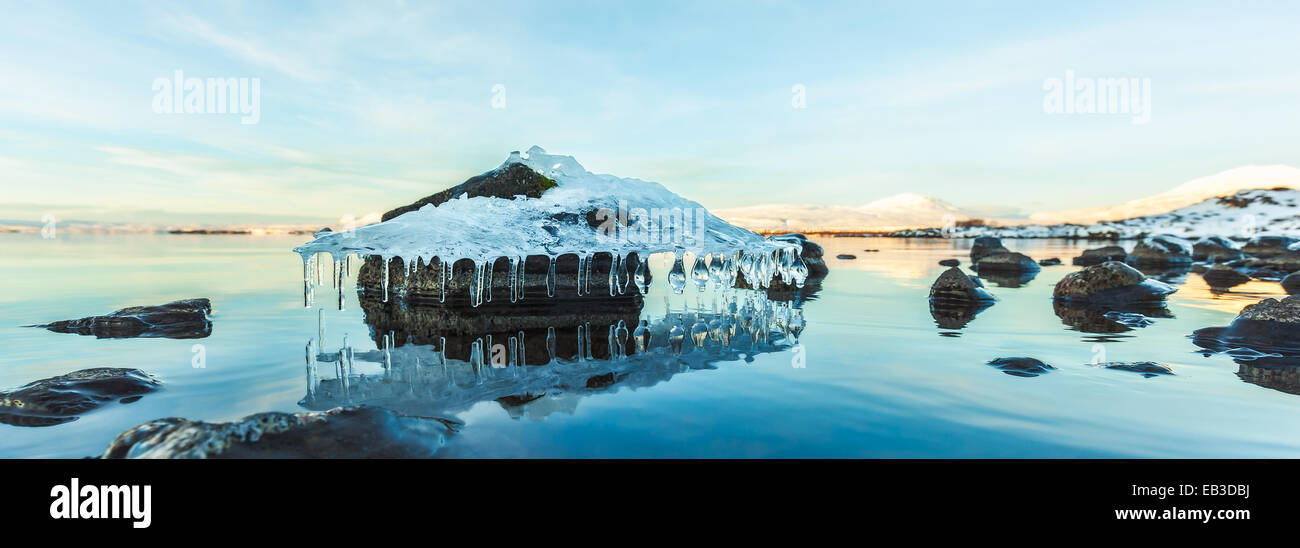 Dramatic icicles hanging on a rock floating in river, Tthingvellir National Park, Blaskogabyggo, Southwestern Iceland, Iceland Stock Photo