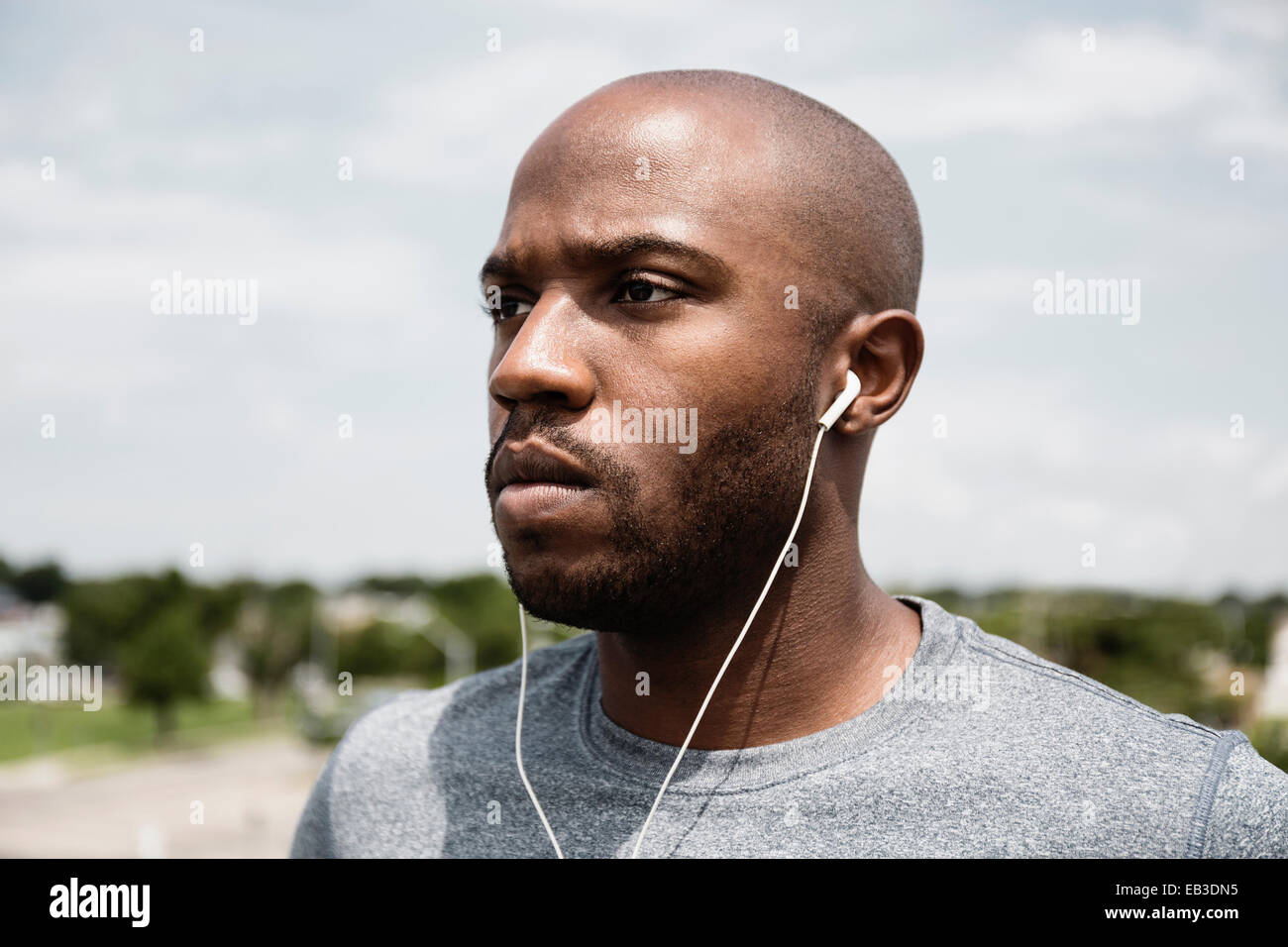 Black runner listening to earbuds Stock Photo
