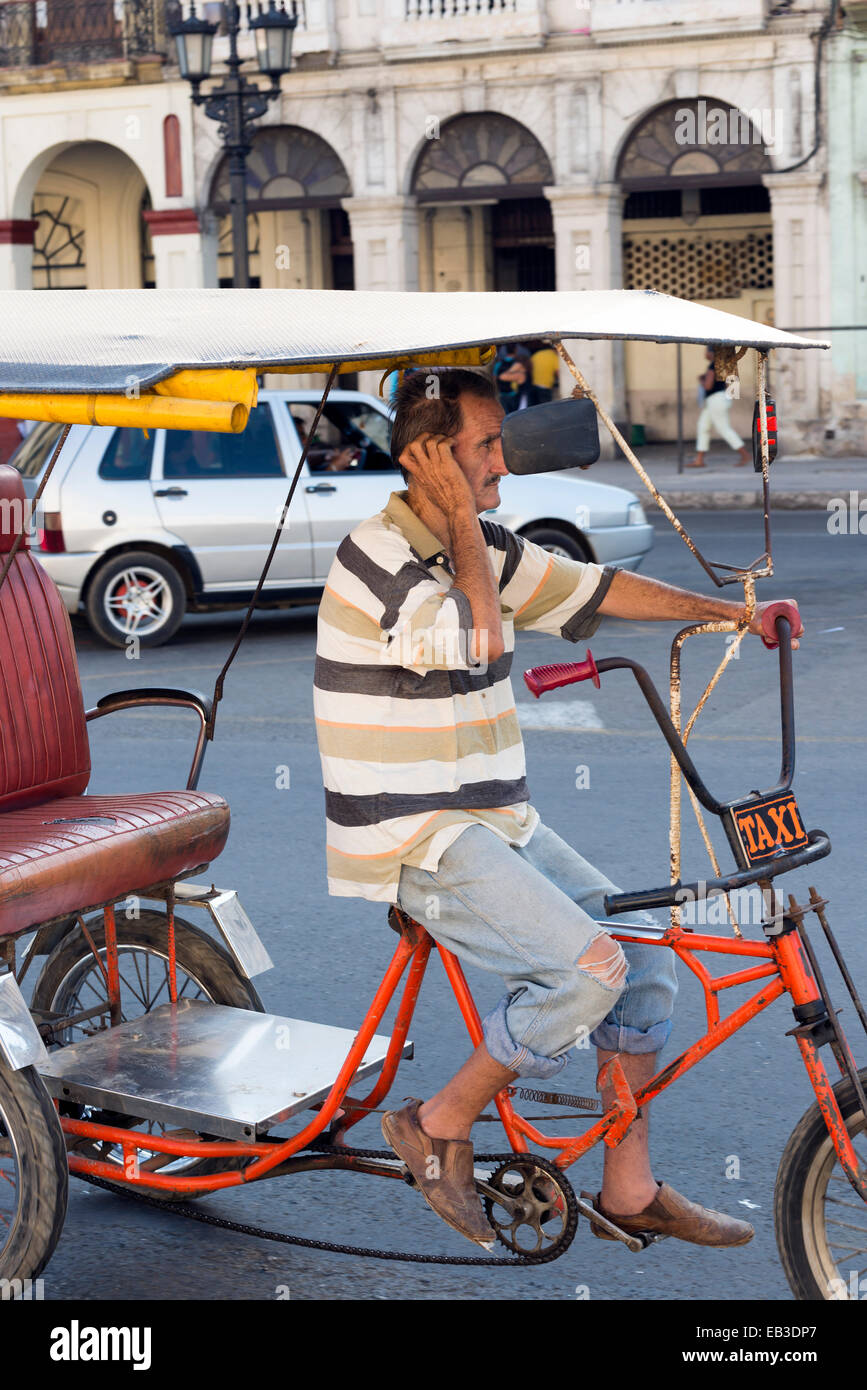 HAVANA, CUBA - MAY 7, 2014: Unidentified  man riding a Pedicab on the street, Havana, Cuba Stock Photo
