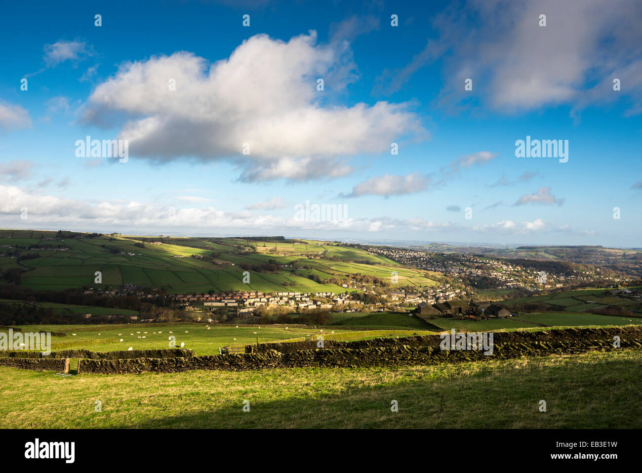 West Yorkshire landscape on a sunny Autumn day looking toward the town of Holmforth over fields and stone walls. Stock Photo