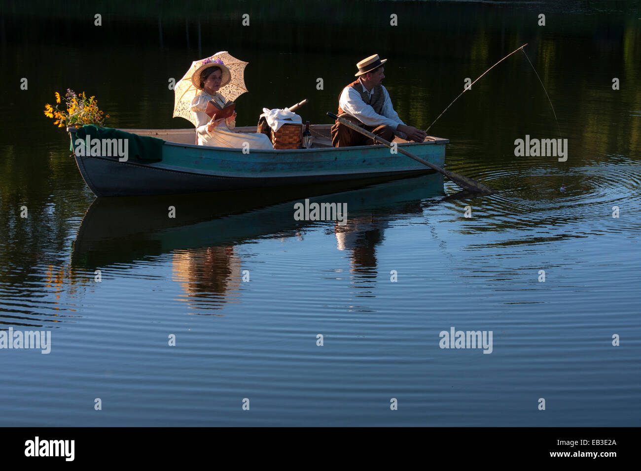 Victorian Couple in a rowboat at sunset Stock Photo