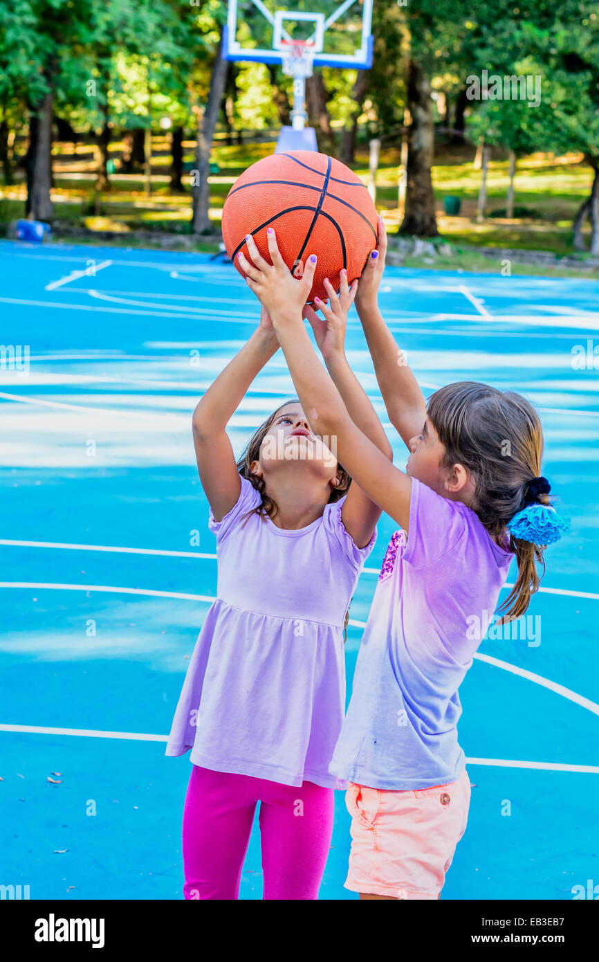 Seven year old girls playing basketball Stock Photo Alamy