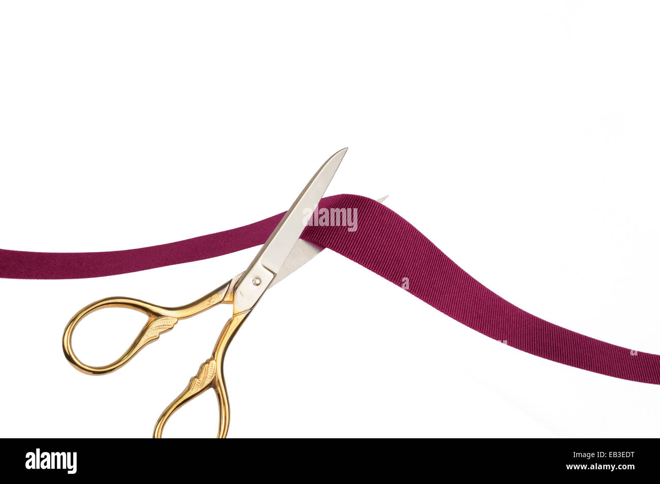 Scissors cutting a red ribbon Stock Photo Alamy